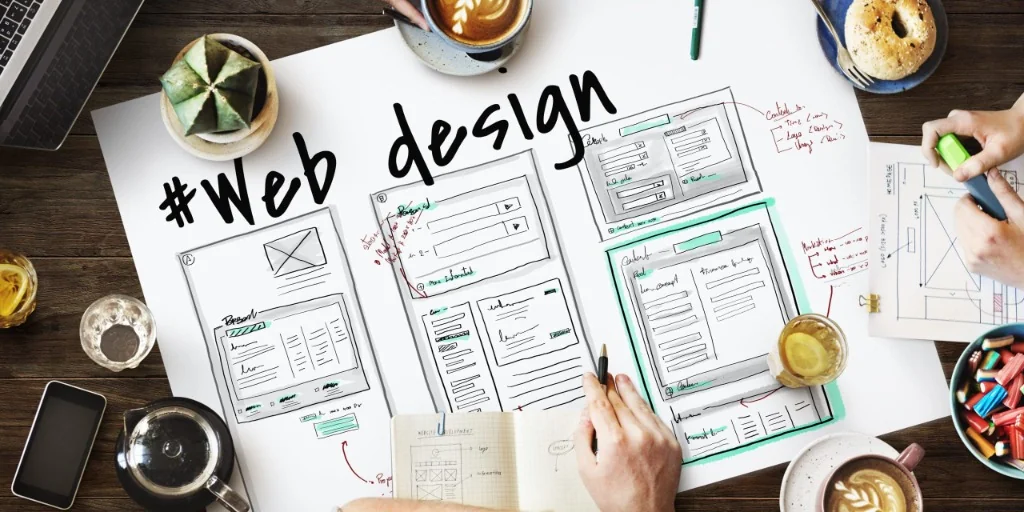 Hands-on responsive web design wireframing, layout sketching, and prototyping process on desk
